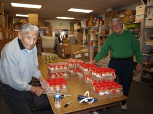 Dedicated volunteers (including their volunteer of the year) unload and sort canned goods
